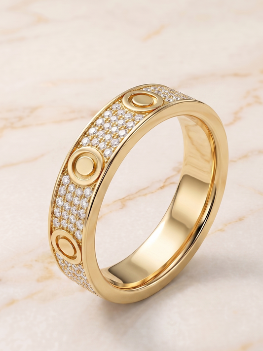 Gold ring with diamond accents on a marble background