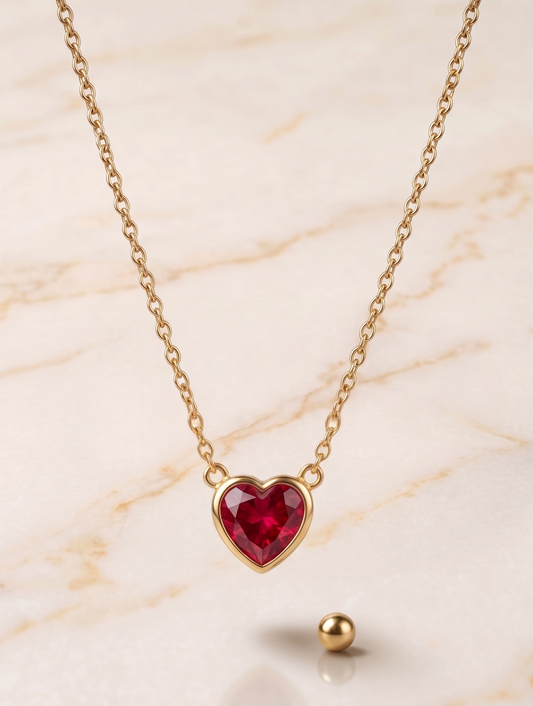 The contrast between the deep red of the faceted crystal and the warm glow of the gold metal creates a unique piece of distinction.